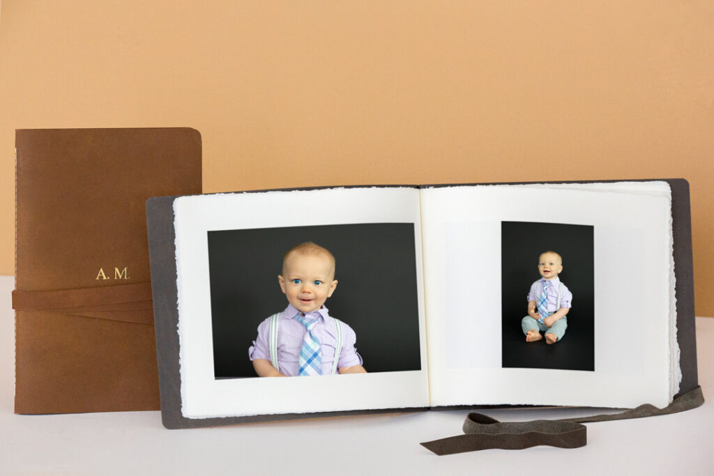 A close-up of our heirloom album showing the handmade archival-quality pages of a family sitter session.