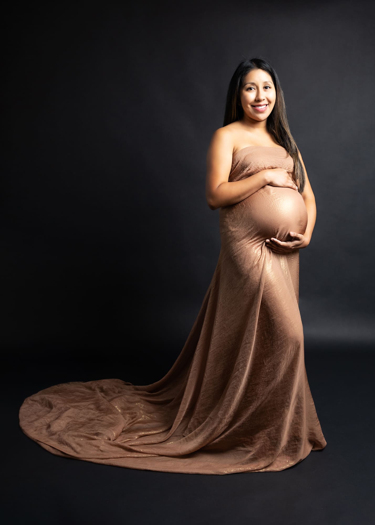 Studio maternity portrait on a dark background captured by San Diego fine art photographer Heirloom Moments
